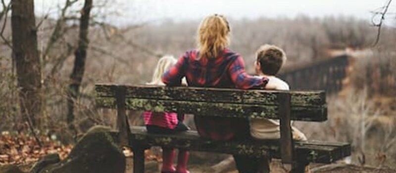 mom with kids on bench