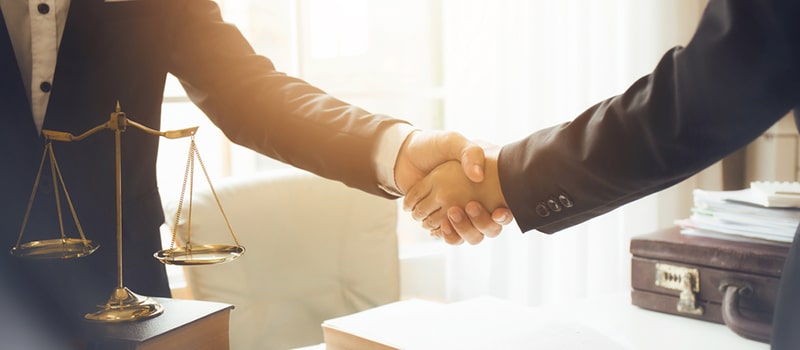 lawyer shaking hands with client