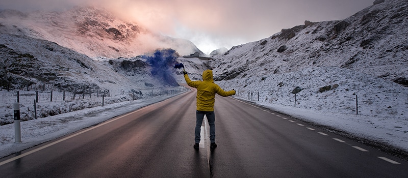 Explorer walking on a street in the middle of snowy landscape